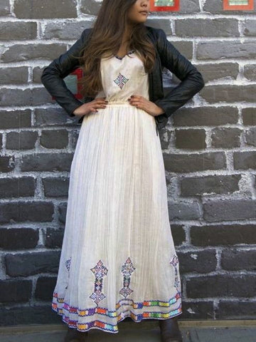 White, sleeveless traditional Ethiopian dress with multicolored cross embroidered motif White, sleeveless traditional Ethiopian dress with multicolored cross embroidered motif