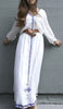 White, long sleeved traditional Ethiopian dress with blue and red cross embroidered motif