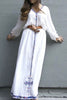 White, long sleeved traditional Ethiopian dress with blue and red cross embroidered motif