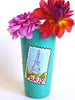 Turquoise vase with Paris landmark postcards