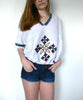 White traditional Ethiopian tunic with multicolored cross embroidered motif