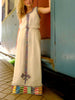 White, sleeveless traditional Ethiopian dress with multicolored cross embroidered motif